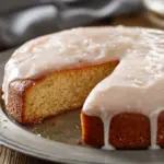 Glazed apple cider doughnut cake topped with sweet glaze and cinnamon sugar