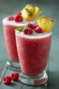Refreshing Raspberry Colada Twist cocktail with raspberries and coconut