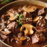 Delicious Slow Cooker Beef Stroganoff served with pasta and herbs.